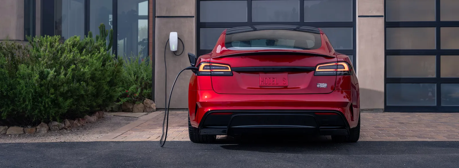 Red Model S charging at home