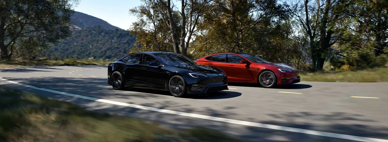 Black and red Model S Plaid driving side by side