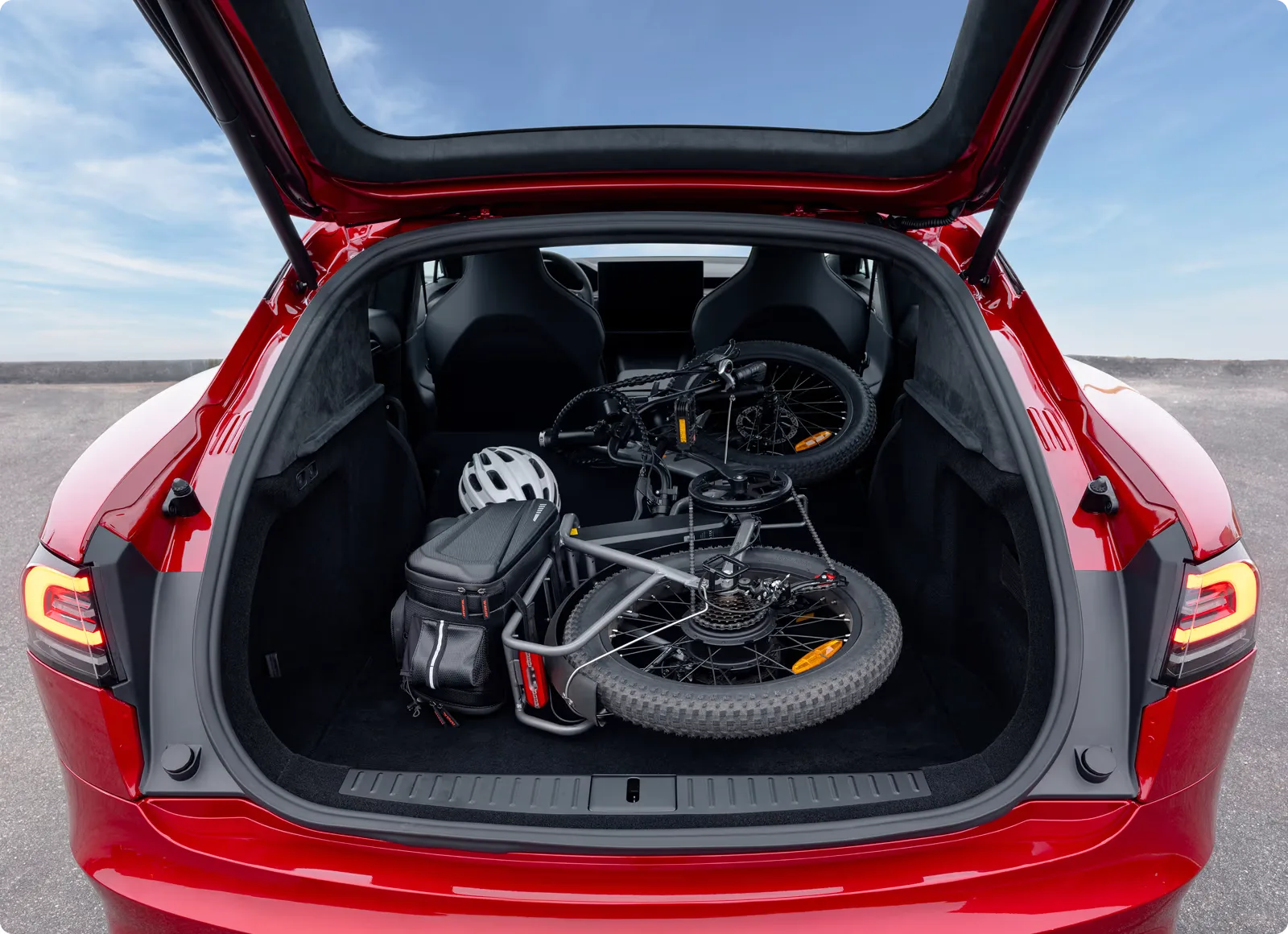 Model S rear hatch open with a folded bike inside